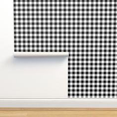 a black and white checkered wallpaper in an empty room