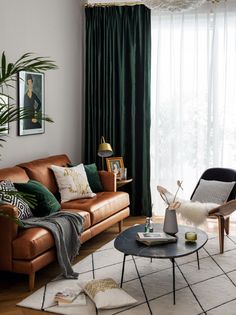 a living room filled with furniture and a window covered in green drapes, next to a coffee table