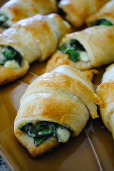 spinach and cheese stuffed pastries on a cutting board