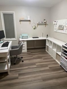 an office with white desks and shelves on the wall