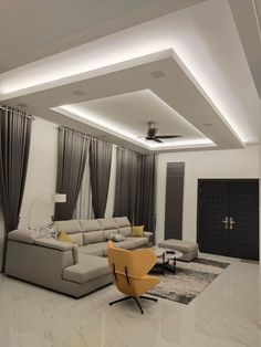 a modern living room with white walls and grey drapes