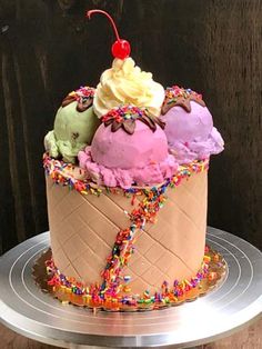 an ice cream sundae cake with sprinkles and cherries on top