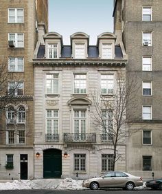 two cars are parked in front of an apartment building