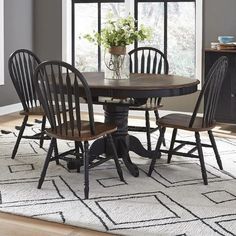 a dining room table with four chairs around it