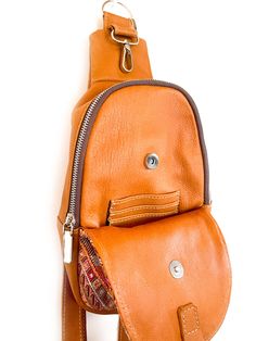 Handcrafted with quality full-grain leather, this crossbody sling bag features a zip-top closure and an interior pocket to keep your everyday essentials secure yet accessible and a small coin purse attached. This bag can be worn across the body (sling) or as a mini backpack. The interior of the bag is lined with beautiful, newly handwoven artisan fabric. Artisan embroidered up-cycle fabric in the outside, making every bag unique. Every bay is one-of-a-kind and slow-crafted by leather artisans in Brown Crossbody Chest Bag With Zipper Pocket, Brown Leather Chest Bag With Zipper, Brown Leather Chest Bag With Zipper Closure, Brown Soft Leather Chest Bag For Everyday Use, Everyday Brown Chest Bag With Zipper Pocket, Brown Crossbody Chest Bag For Everyday Use, Brown Leather Chest Bag For Everyday Use, Brown Crossbody Saddle Bag With Zipper, Leather Chest Bag With Zipper Closure For On-the-go