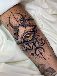 a person with a tattoo on their leg that has an eye and stars in it