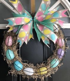 an easter wreath is hanging on the front door