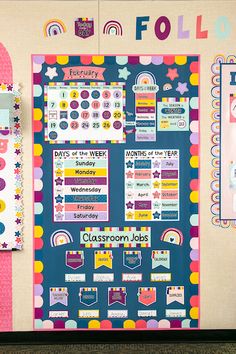 a bulletin board with lots of stickers on it in front of a classroom wall