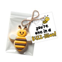 a cookie shaped like a bee with a card attached to it