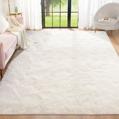 a large white rug in a living room