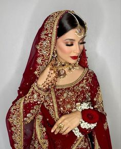 a woman in a red wedding dress and jewelry