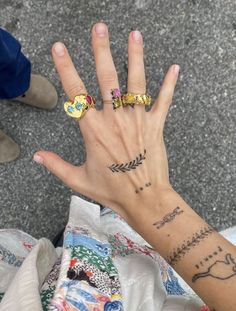 a person's hand with tattoos on it