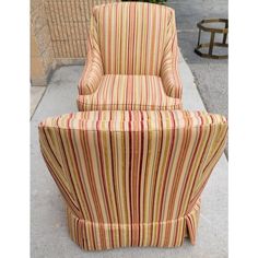 a striped chair and ottoman sitting on the sidewalk