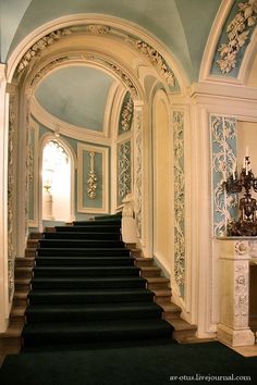 a staircase leading up to an ornately decorated room