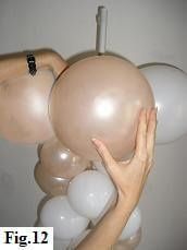 a woman is holding balloons in her hand and reaching up to grab them from the ceiling