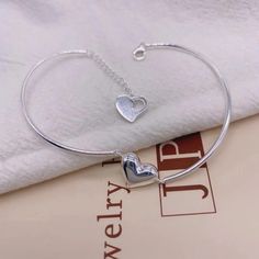 Bracelet with heart shape charm Silver Heart Charm Bracelet For Friendship, Heart Shaped Bangle For Valentine's Day, Minimalist Silver Double Heart Bracelets, Silver Heart Bead Bracelet For Friendship, Silver Heart Beads Bracelet For Friendship, Adjustable Silver Heart Bangle Bracelet, Silver Heart Bracelet For Mother's Day, Silver Heart Charm Bangle Bracelet, Sterling Silver Bracelets With Heart Charm For Friendship