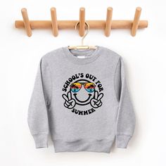 Looking for a cute sweatshirt for your kids? We have the perfect School's Out Smiley Face graphic sweatshirt addition to their closet! Also available in toddler sweatshirts. Cartoon Print Long Sleeve Sweatshirt For School, Fun Cartoon Print Sweatshirt, Cute Crew Neck Sweatshirt For School, School Crew Neck Sweatshirt With Graphic Print, Cute Letter Print Sweatshirt For School, Long Sleeve Sweatshirt With Text Print For School, Smiley Face Graphic, School's Out For Summer, Face Graphic