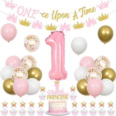 a first birthday cake surrounded by balloons and confetti with the number one on it