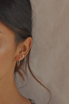 a close up of a person wearing some kind of earring with an ear clip