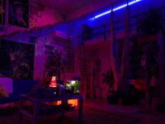 a living room filled with furniture and purple lighting