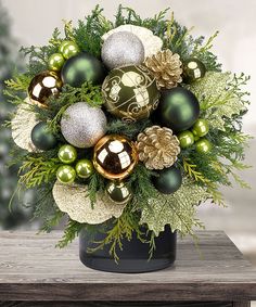 a vase filled with green and gold ornaments