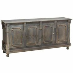 an old wooden sideboard with four doors