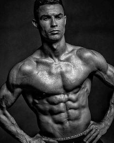 a man with no shirt on posing for a photo in front of a black and white background