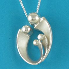 "Mom of three mother's pendant may otherwise be interpreted as celebrating your loving family of four! Our expressive, egg-shaped creation is hand sculpted in sterling silver. Size: 1\" X 5/8\": $158. Bright polished heads and raised curves are contrasted with recessed contours that have a soft satin finish. Fully finished reverse. This richly dimensional pendant includes a sterling chain that threads through the design's integrated and invisible chain bail. The included US-made 1.2mm curb link Silver Oval Necklace For Anniversary, Silver Oval Necklace For Anniversary Gift, Sterling Silver Oval Pendant Necklace For Mother's Day, Sterling Silver Oval Pendant Necklace As Gift For Mom, Oval Jewelry For Mother's Day Gift, Oval Sterling Silver Necklace For Mom, Hallmarked Jewelry For Mother's Day, Sterling Silver Oval Necklace For Mom, Teardrop Pendant Jewelry For Anniversary And Mother's Day