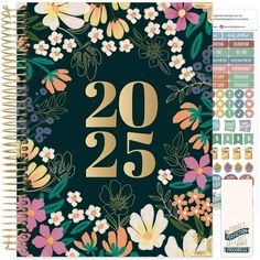 a spiral notebook with flowers and the number twenty five in gold foil on top of it