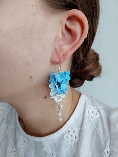 https://purplebeestudio.etsy.com Handmade unique polymer clay chandelier earrings in sky blue colour. The polymer clay flowers are made by me without using any molds. These very elegant earrings will become your favorits for many occasions day or night. Earrings made with brass ear wire. The earrings are very light and comfortable to wear all day. SHIPPING: Your order will be dispatched in a securely packed cardboard box. Product care:  - To ensure the product quality and durablility, avoid cont Handmade Flower Dangle Earrings In Polymer Clay, Handmade Flower Dangle Jewelry In Polymer Clay, Handmade Blue Drop Bridal Earrings, Handmade Blue Bridal Drop Earrings, Handmade Blue Flower Earrings For Wedding, Wedding Flower Earrings In Polymer Clay, Handmade Blue Bridal Earrings For Wedding, Polymer Clay Flower Drop Earrings For Wedding, Blue Dangle Flower Earrings For Wedding