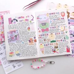 an open book with stickers on it next to some scissors and other items that include beads