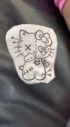 a hello kitty sticker on the back of a person's shirt with an image of a cat