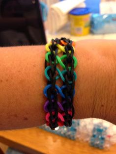 a person's arm with several bracelets on it