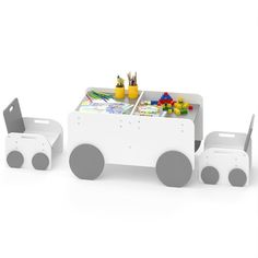 a toy train table and chair set with paintbrushes on the top, pencils in plastic containers next to it