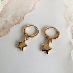 "✔️Star Hoop earrings made of 24K gold plated brass ✔️ This listing is for a pair of earrings - (2-star hoops) Modern & minimalist hoop earrings with a star-shaped charm. ✔️ So dainty and easy to put in ✔️ A very elegant and dainty pair of star charm earrings that upgrade your everyday look. These hoop earrings look beautiful layered with other gold earrings or even worn alone for a minimal look. They're tiny perfect for a child or for an adult. That's why they are considered your best choic Gold Star-shaped Hoop Earrings With Ear Wire, Gold Star Charm Hoop Earrings, Gold Hoop Earrings With Star Charm For Gift, Gold Hoop Earrings With Star Charm As A Gift, Gold Star-shaped Single Hoop Earring, Handmade Gold Star Hoop Earrings, Gold Plated Star Shaped Hoop Earrings, Gold Plated Star-shaped Hoop Earrings, Gold Star-shaped Hoop Earrings