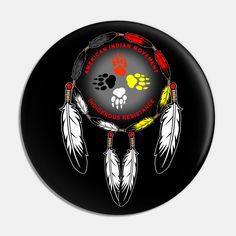 a black button with an image of a bear paw and dream catchers on it