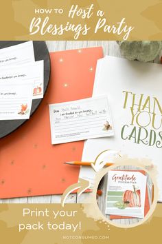 a table topped with lots of cards and paper on top of each other, next to a pumpkin