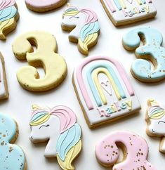 decorated cookies in the shape of unicorns and numbers