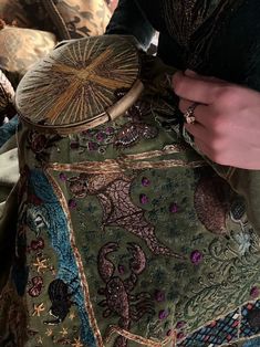 a close up of a person sewing on a piece of cloth