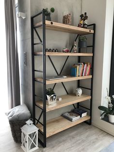 a bookshelf in the corner of a room next to a window with plants on it