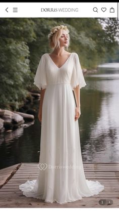 a woman in a white dress standing on a dock