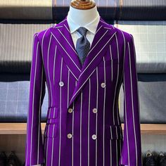 Six Button Double Breasted Peak Label Pinstripe Pattern One Chest Pocket Ticket Pockets Two Flap Front Pocket Color: Purple Tailored Striped Suits With Double Button Closure, Striped Double Breasted Suit With Double Button For Semi-formal, Tailored Striped Double-breasted Suits, Striped Double-breasted Suit With Double Button Closure, Striped Double Breasted Suit For Semi-formal Occasions, Fitted Striped Double Breasted Suit For Semi-formal Occasions, Semi-formal Striped Double Breasted Suit, Fitted Double-breasted Purple Blazer, Fitted Striped Blazer With Button Closure