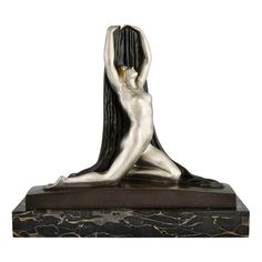 a sculpture of a woman with long hair sitting on top of a black marble base