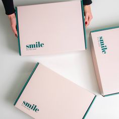 three boxes with the words smile on them are being held by someone's hands