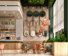 the interior of a cafe with tables, chairs and mirrors on the wall above them