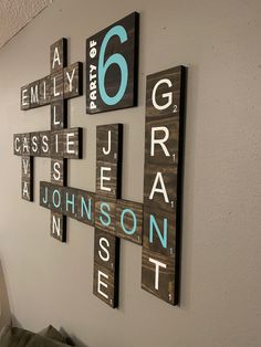 the wall is decorated with wooden blocks that spell out different names and numbers in blue