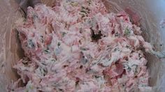 a bowl filled with food sitting on top of a red table cloth covered in white frosting