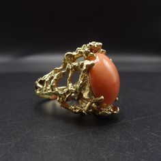 "ESTATE 14 KARAT GOLD and SALMON CORAL RING DESCRIPTION: This elegant ring features a large cabochon of pink salmon coral, placed in an organic setting of heavy gauge 14 karat yellow gold. This ring will be a valuable addition to your collection of fine vintage jewelry. MEASUREMENTS: Ring face measures 1\" north to south RING SIZE: 6 Domed coral cabochon measures 18mm x 13mm x 7mm WEIGHT: 15.9 grams SIGNED: no GOLD: Marked 14K" Formal Coral Oval Jewelry, Formal Coral Ring, Oval Coral Cabochon Jewelry, Formal Coral Jewelry With Cabochon Details, Coral Oval Cabochon Jewelry, Formal Coral Jewelry With Cabochon, Turquoise Men, Coral Ring, American Jewelry