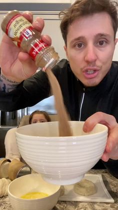 a man is pouring something into a bowl