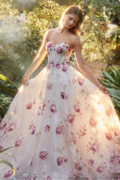 This strapless organza peony print ball gown is a breathtaking and romantic choice for any fairytale garden. This strapless bodice is a full, floor-length skirt made of delicate layered organza fabric. The gown features a stunning peony print that adds a pop of color to the off white background. A sheer boned bodice is adorned with coordinating hot stones for some added glitz. The detachable puff sleeves give you the option to change up the look and add a touch of drama to the design. Long Puff Sleeve Dress, فستان زهري, Andrea And Leo, Fairytale Garden, Strapless Organza, Peony Print, Boned Bodice, Hot Stones, Unique Prom Dresses